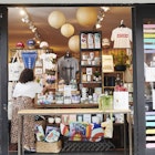An employee adjusts face masks displayed for sale in an open window for curbside pickup at a Lockwood store in the Astoria neighborhood in the Queens borough of New York, U.S., on Friday, June 5, 2020. For New York's small businesses, which depend almost entirely on city residents, Monday marked a vital moment to start bringing in the customers and revenue they lost during the shutdown an undertaking all the more precarious with the current social unrest. Photographer: Gabby Jones/Bloomberg via Getty Images