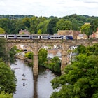 A train crossing the impressive Knaresborough Viaduct in the town of Knaresborough in Yorkshire
1354307497
knaresborough viaduct, high bridge, line, northern trains, northern train, st johns, saint johns, st john the baptist, boating, river nidd, nidd, attraction, attractions, destination, united kingdom, great britain, britain, yorks, yorkshire and the humber, historic