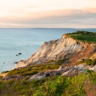 Sun sets illunimating sandy cliffs of Moshup Beach in Aquinnah, on Martha’s Vineyard island, in Massachusetts. It is a favorite attraction for tourists looking for a spiritual connection., License Type: media, Download Time: 2025-01-28T16:39:19.000Z, User: katelyn.perry_lonelyplanet, Editorial: false, purchase_order: 65050 - Digital Destinations and Articles, job: Lonely Planet WiP, client: Lonely Planet WiP, other: KP