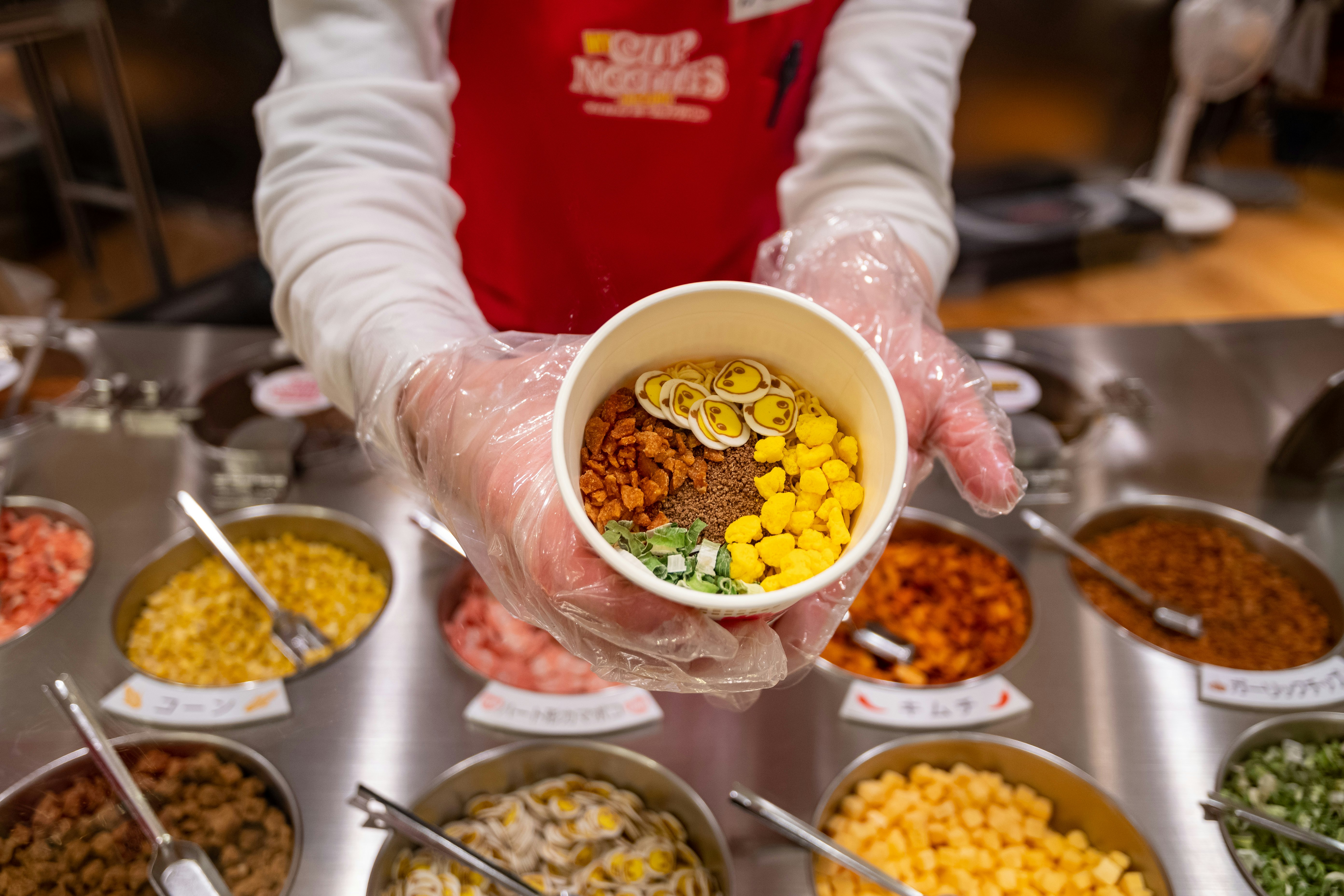 Inside Cupnoodles Museum, making a personalized soup at CUPNOODLES Factory.