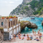 CAPRI, ITALY - SEPTEMBER 22, 2023: Holiday makers relax at Marina Piccola on Capri Island, famed for rugged landscape, upscale hotels and luxury designer shopping, License Type: media, Download Time: 2025-01-30T22:19:19.000Z, User: sashabrady26, Editorial: true, purchase_order: 65050 - Digital Destinations and Articles, job: Lonely Planet, client: Photo haul, other: Sasha Brady