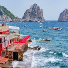 CAPRI, ITALY - SEPTEMBER 22, 2023: Tour boats take tourists to Faraglioni Rocks. Capri island is famed for rugged landscape. In the summer its dramatic cove-studded coastline draws many yachts, License Type: media, Download Time: 2025-01-30T22:19:19.000Z, User: sashabrady26, Editorial: true, purchase_order: 65050 - Digital Destinations and Articles, job: Lonely Planet, client: Photo haul, other: Sasha Brady