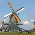 Traditional windmills with blue sky, A small village with tourist, Zaanse Schans is a neighborhood in the Dutch town Zaandijk near Amsterdam, Noord Holland