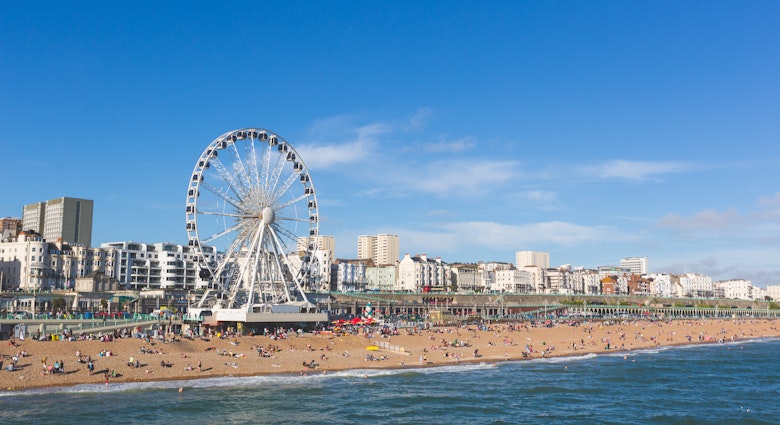 Brighton view of seaside from the pier. Panoramic shot with the famous ferris wheel, the stones beach with unrecognizable persons on a sunny summer day., License Type: media, Download Time: 2025-01-13T01:01:33.000Z, User: claramonitto, Editorial: false, purchase_order: 56530 - Guidebooks, job: Global Publishing-WIP, client: Great Britain 16 , other: Clara Monitto