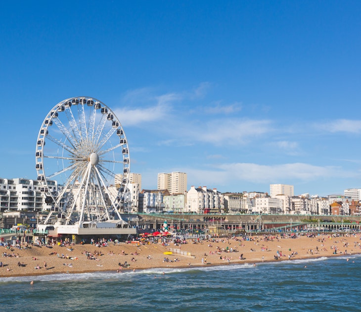 Brighton view of seaside from the pier. Panoramic shot with the famous ferris wheel, the stones beach with unrecognizable persons on a sunny summer day., License Type: media, Download Time: 2025-01-13T01:01:33.000Z, User: claramonitto, Editorial: false, purchase_order: 56530 - Guidebooks, job: Global Publishing-WIP, client: Great Britain 16 , other: Clara Monitto